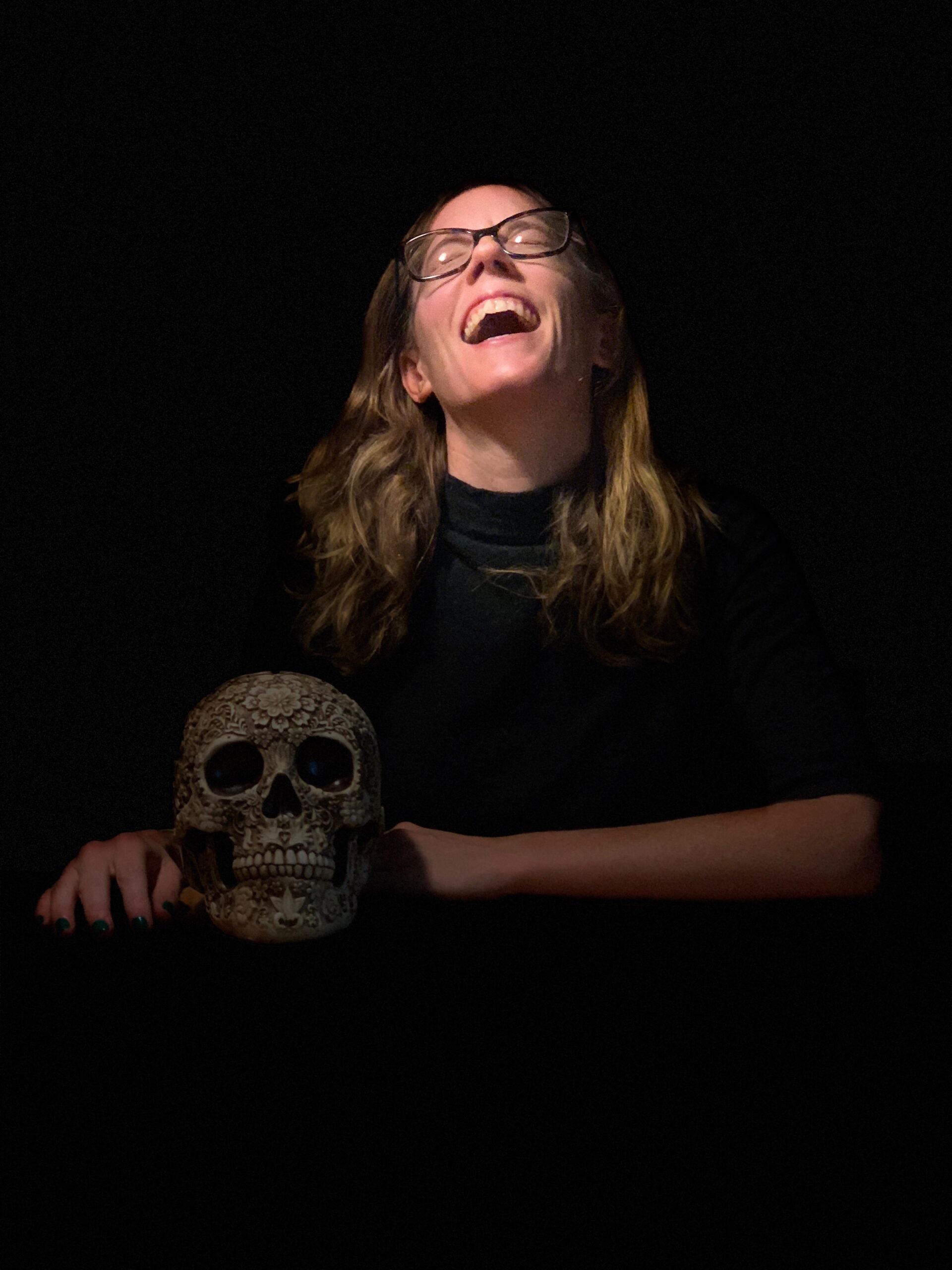 Ritchey laughing and holding a skull