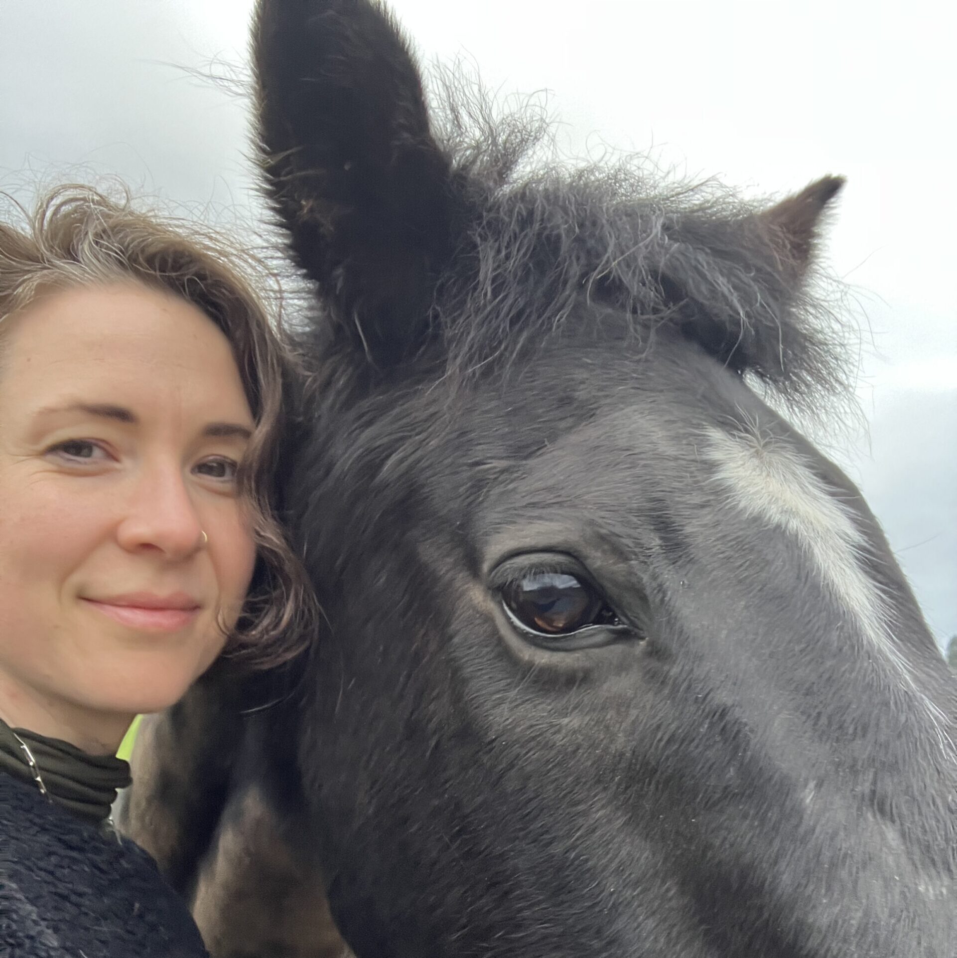Flo Fitzgerald-Allsopp with a black and white horse
